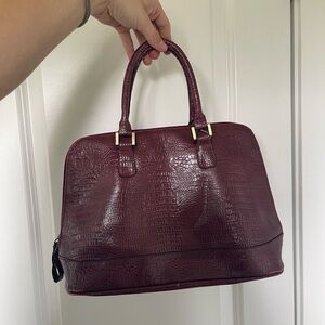 Burgundy/red crocodile print handbag with gold hardware